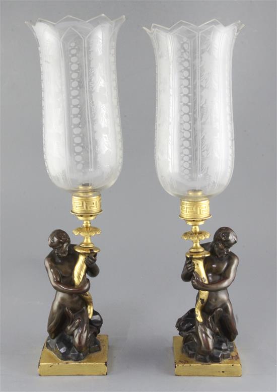 A pair of 19th century bronzed stoneware candlesticks, after a design by John Flaxman, height 21.5in.